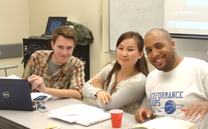 Three students in classroom working together