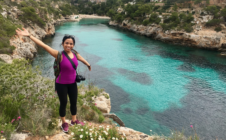 Study abroad student next to blue water