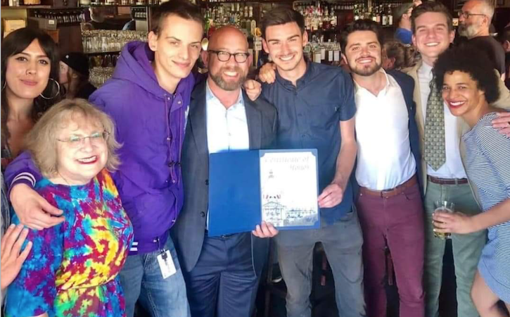 Internship students together smiling and holding certificate