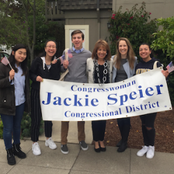 Samantha Logan with other holding a sign